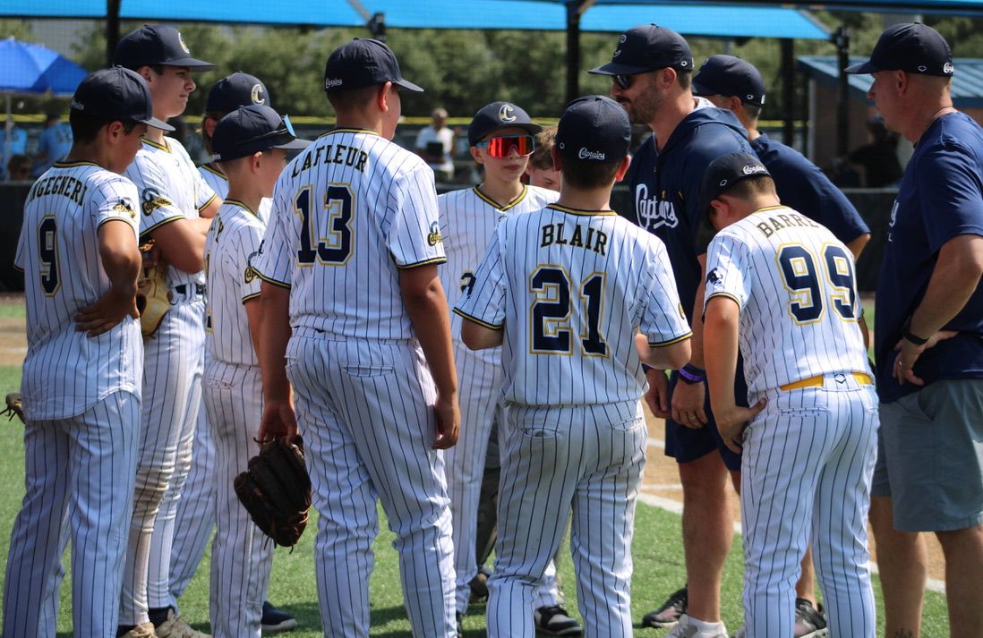 Captains players in a huddle in pinstripe uniforms